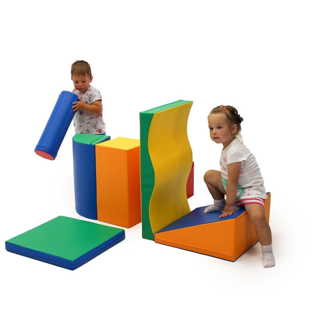 1. Two children playing with multicolor foam blocks in a playroom setting