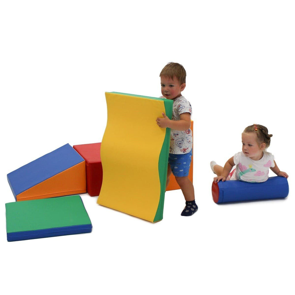 1. Two children playing with multicolor foam blocks in a playroom