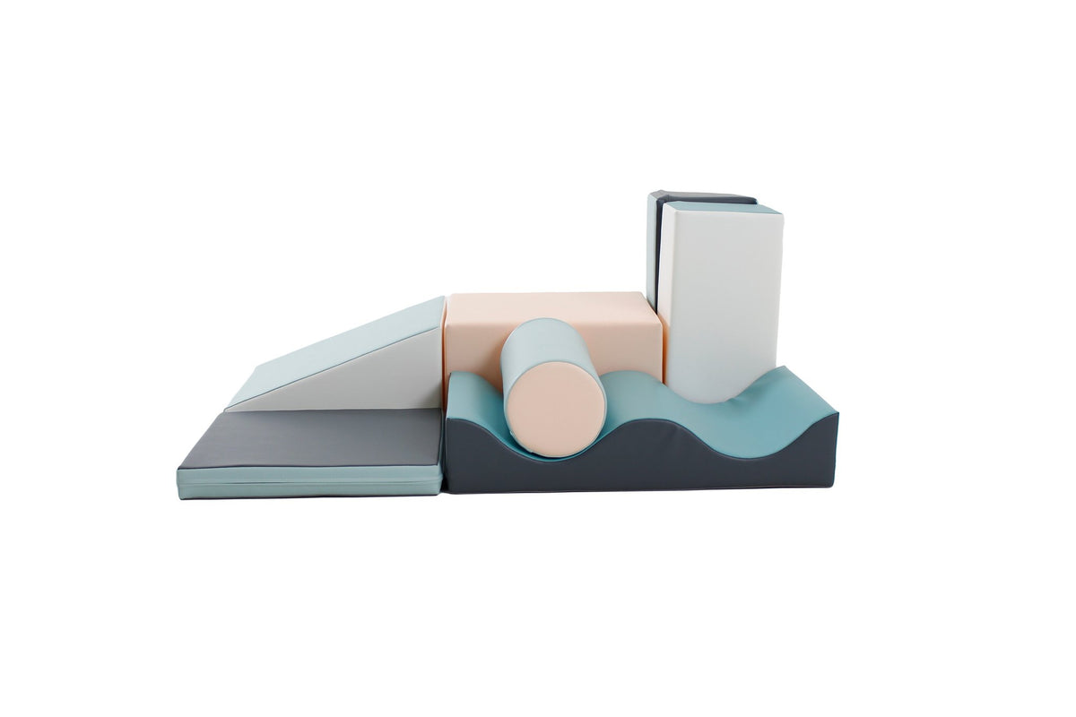 3. Close-up of IGLU Discoverer 7-piece foam block set in light pastel colors showing various shapes including a cylinder and wave block on a white background