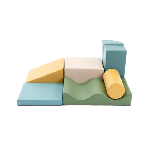 1. IGLU Discoverer 7-piece foam block set in pastel turquoise, yellow, and green arranged in a playful layout on a white background