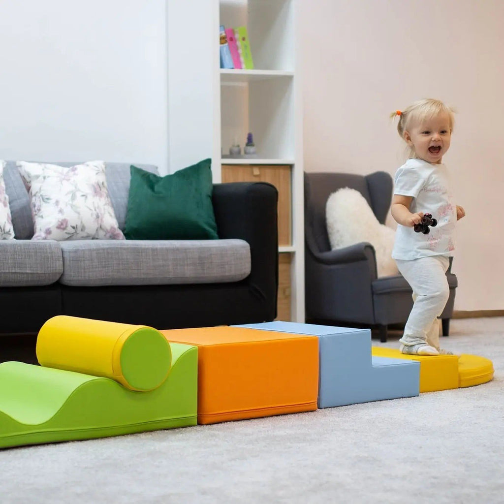 1. Toddler playing on IGLU Explorer foam block set in light multicolor in a living room