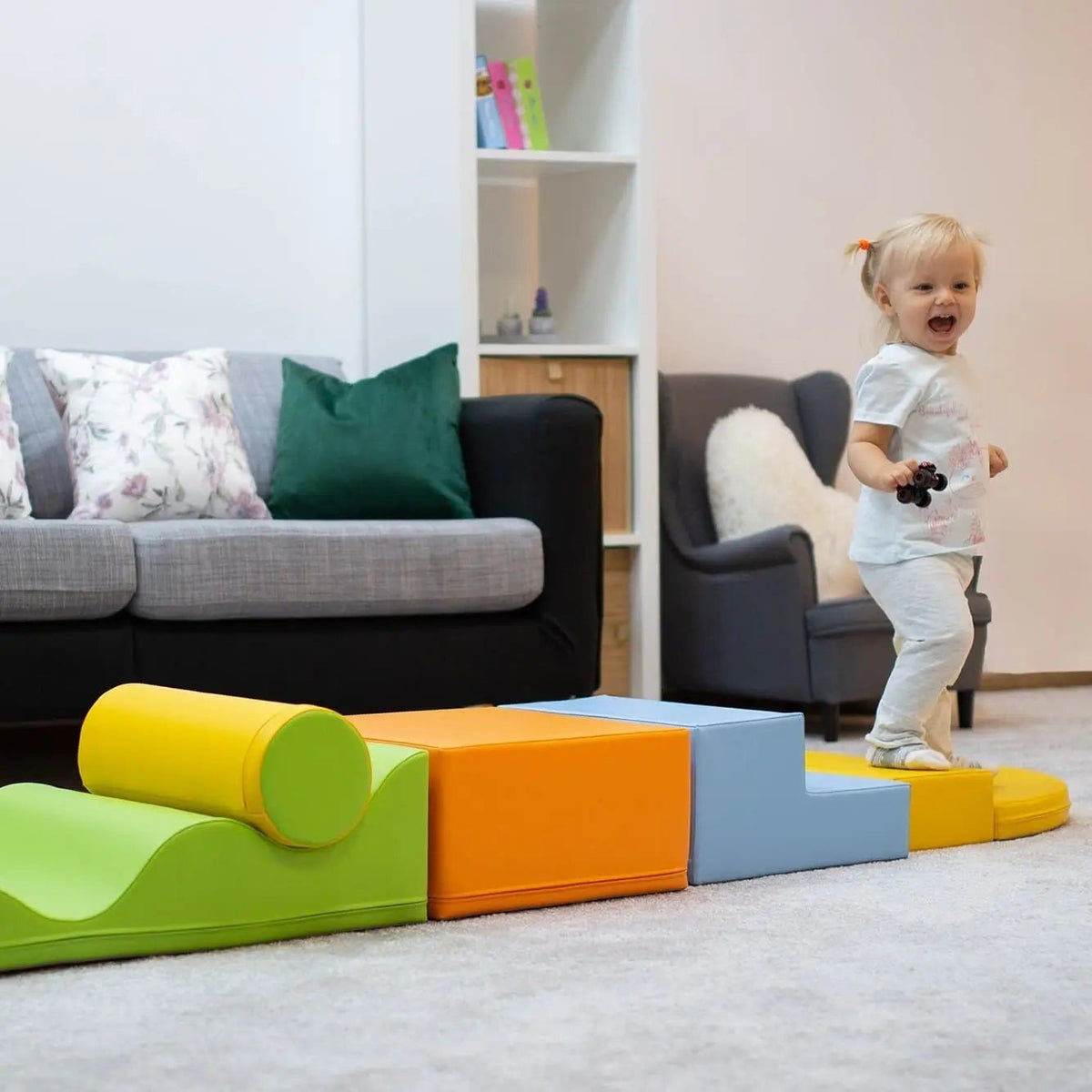 1. Toddler playing on IGLU Explorer foam block set in light multicolor in a living room