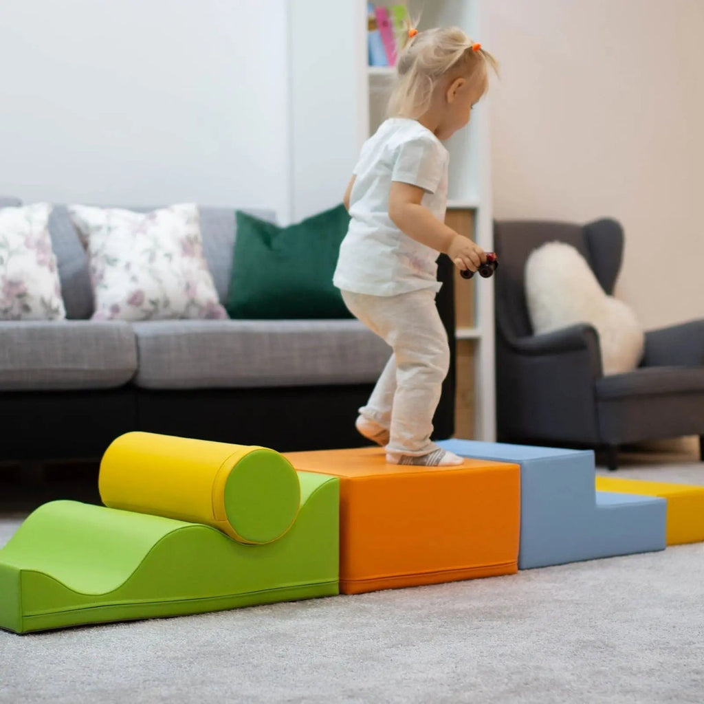1. Toddler walking on IGLU Explorer foam block set in light multicolor in a living room
