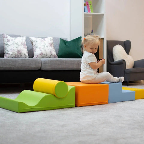 1. Child sitting on IGLU Explorer foam block set in light multicolor in a living room