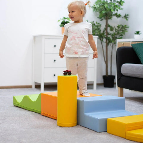 1. Child standing on IGLU Explorer foam block set in light multicolor in a cozy living room