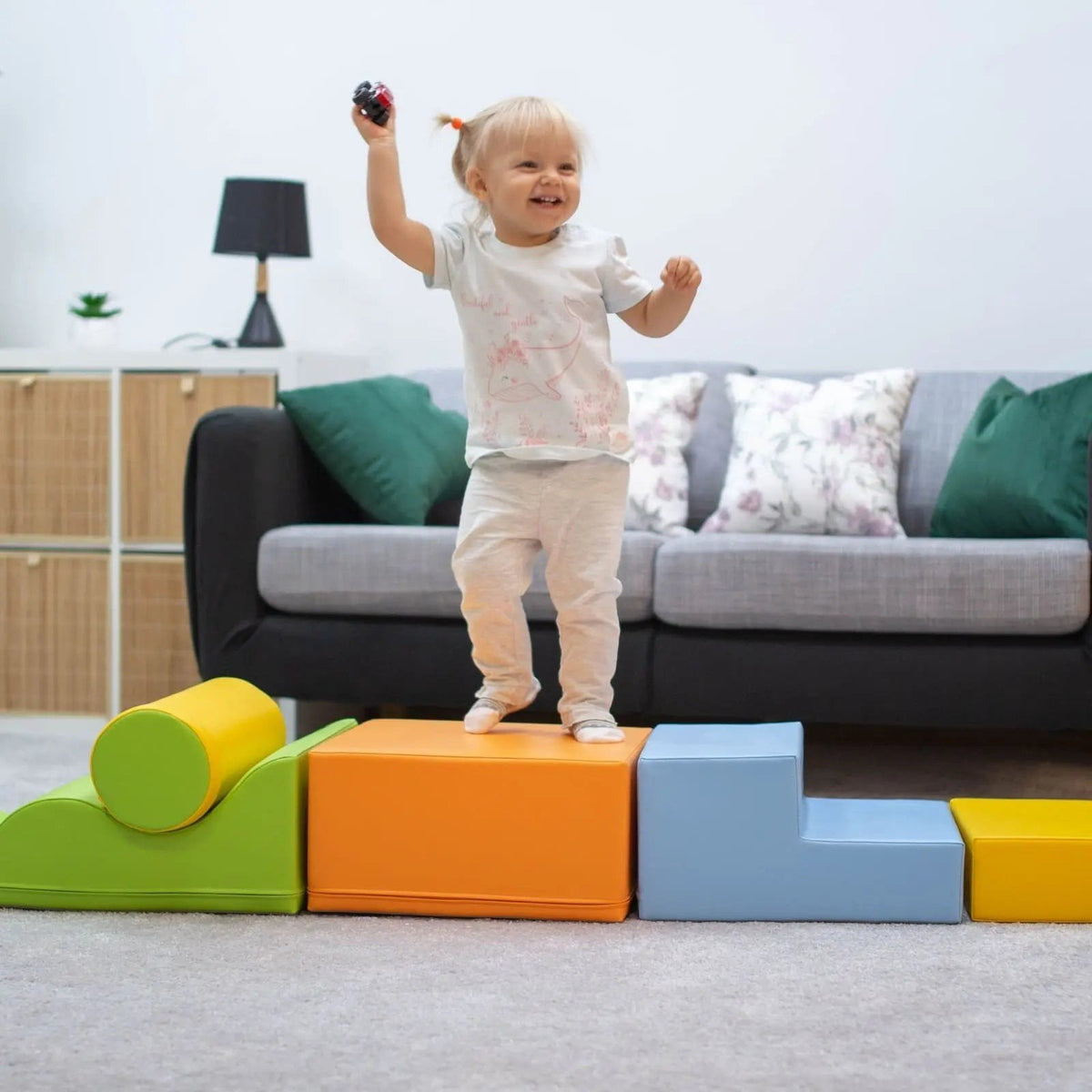 1. Child playing on IGLU Explorer foam block set in light multicolor in a living room