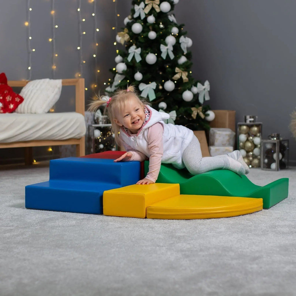 1. Girl climbing on multicolor foam blocks in playroom