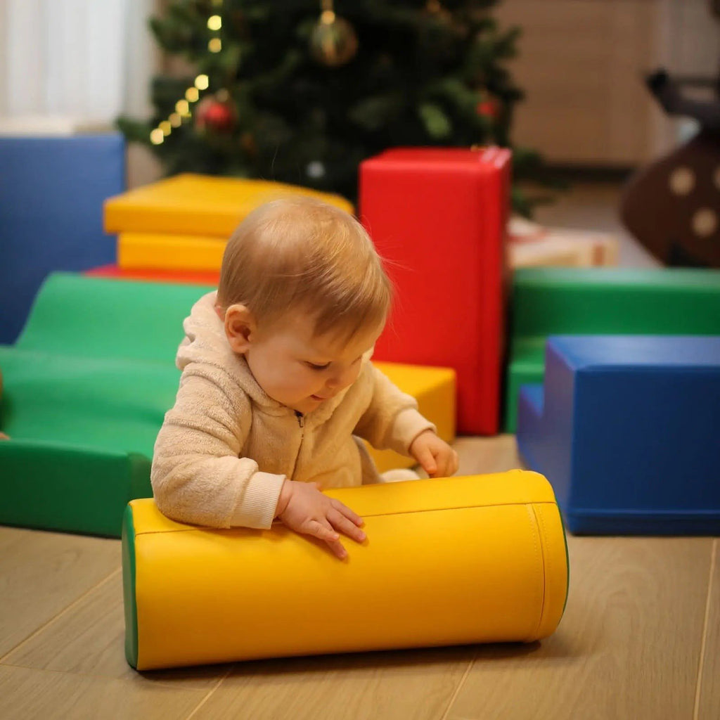 1. Baby playing with yellow foam cylinder in playroom