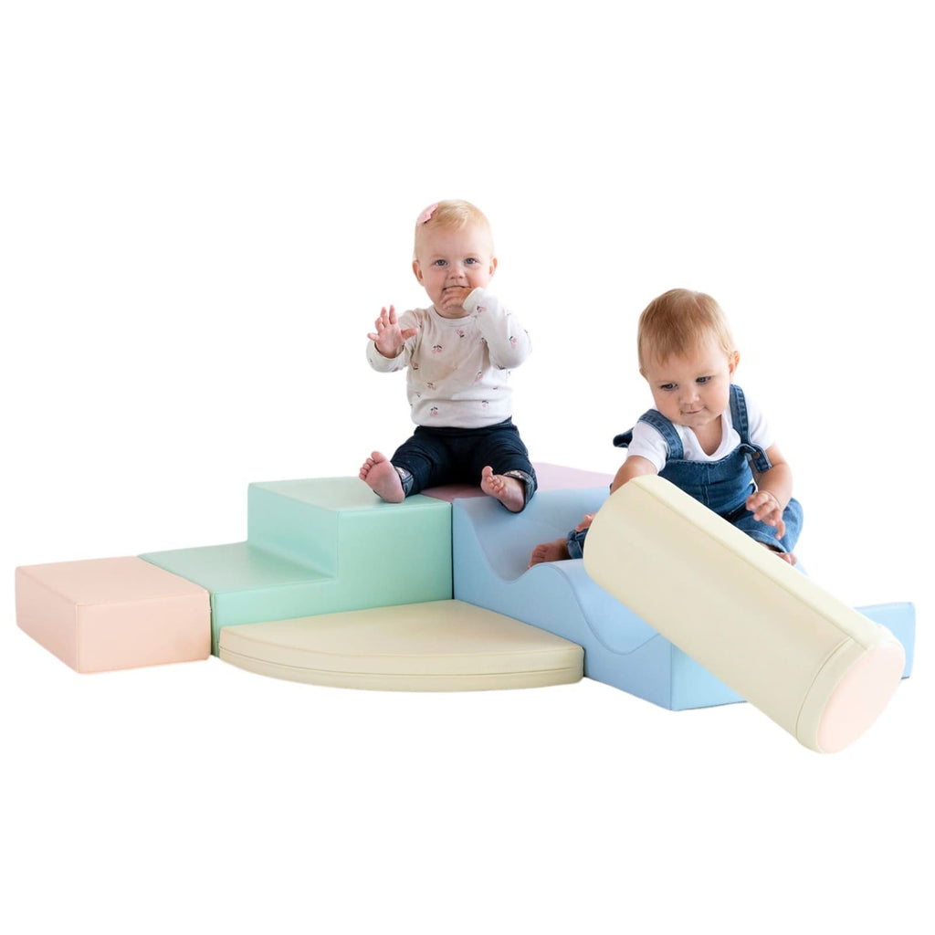 1. Two toddlers playing on pastel foam blocks in a studio