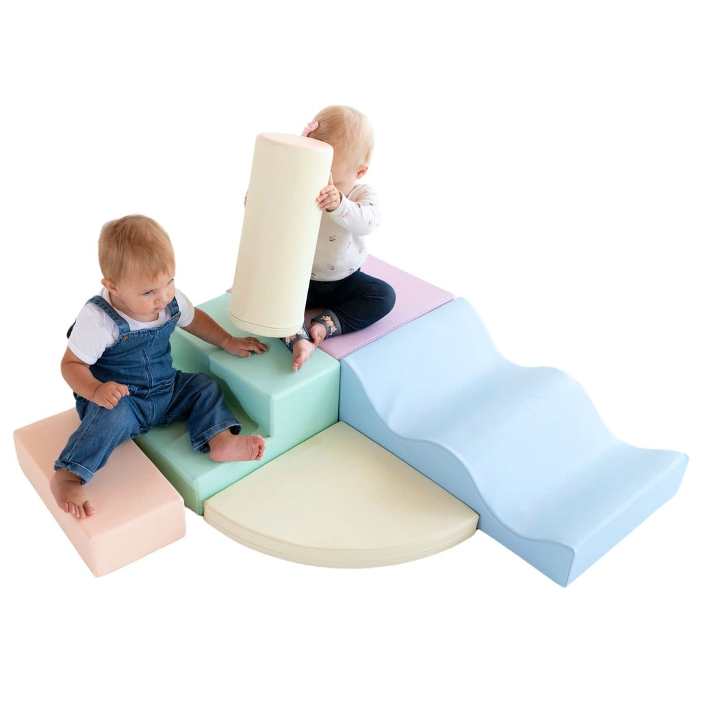 1. Two toddlers playing on pastel foam blocks in a studio