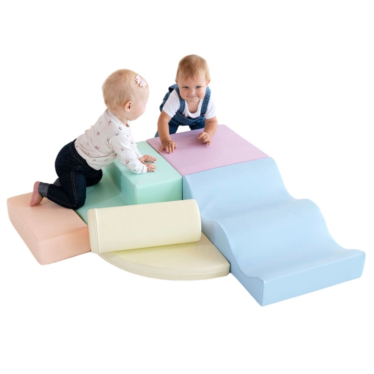 1. Two children playing on pastel foam blocks in a studio