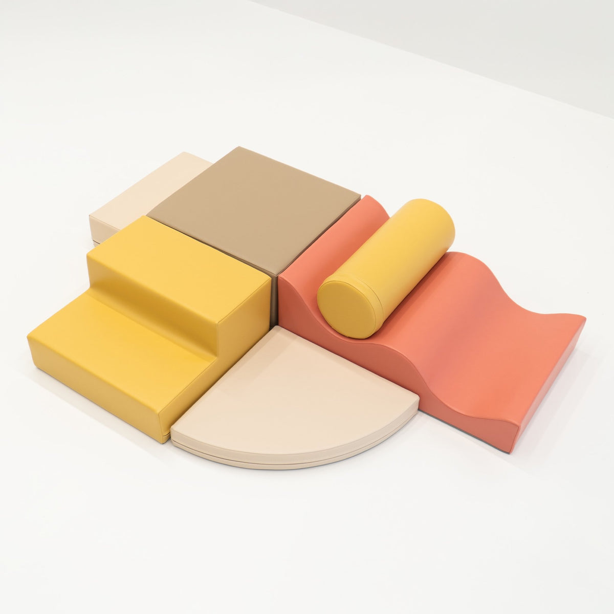 2. Top view of pastel pink and yellow foam blocks arranged on a white background