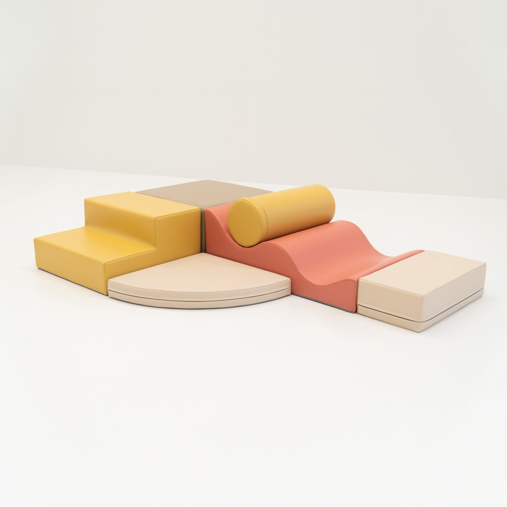 2. Pastel pink and yellow foam blocks arranged on a white background