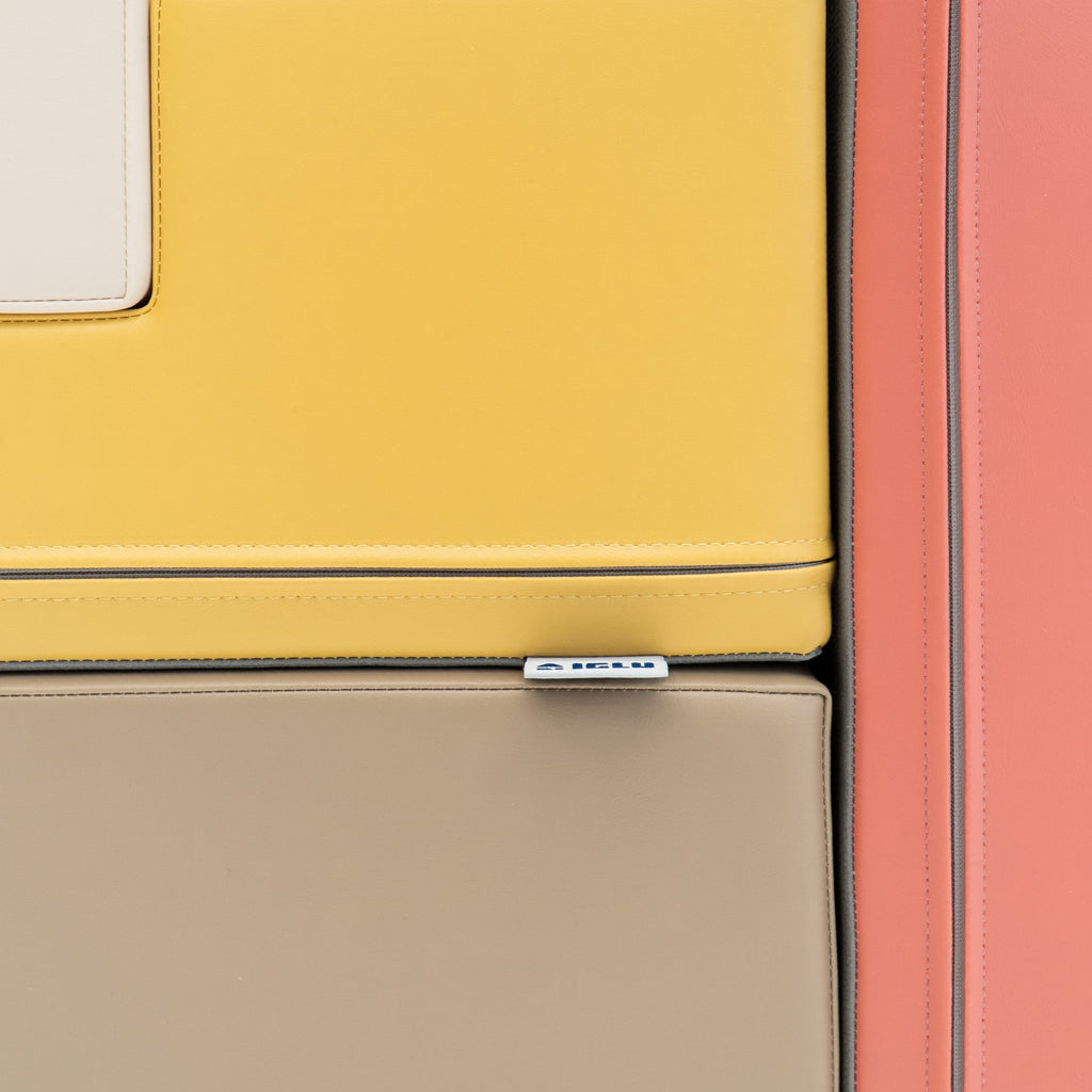 3. Close-up of IGLU logo tag on pastel pink and yellow foam block
