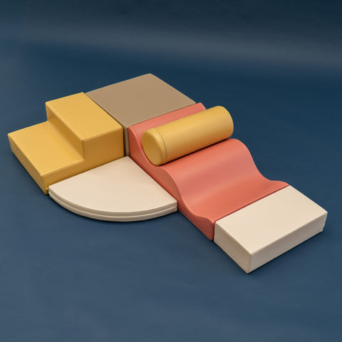 2. Pastel pink and yellow foam blocks arranged on a dark background