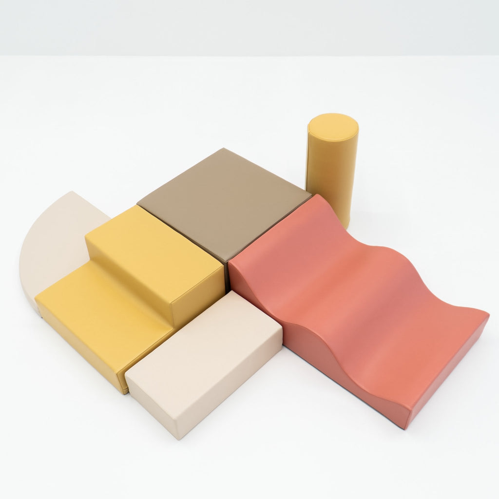 2. Pastel pink and yellow foam blocks arranged on a white background