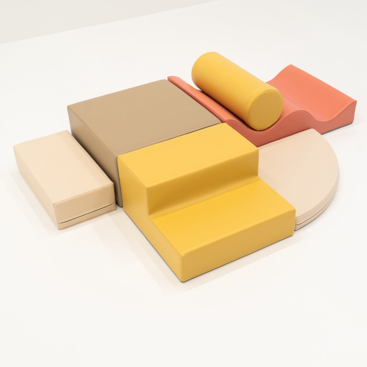 2. Pastel pink and yellow foam blocks arranged on a white background