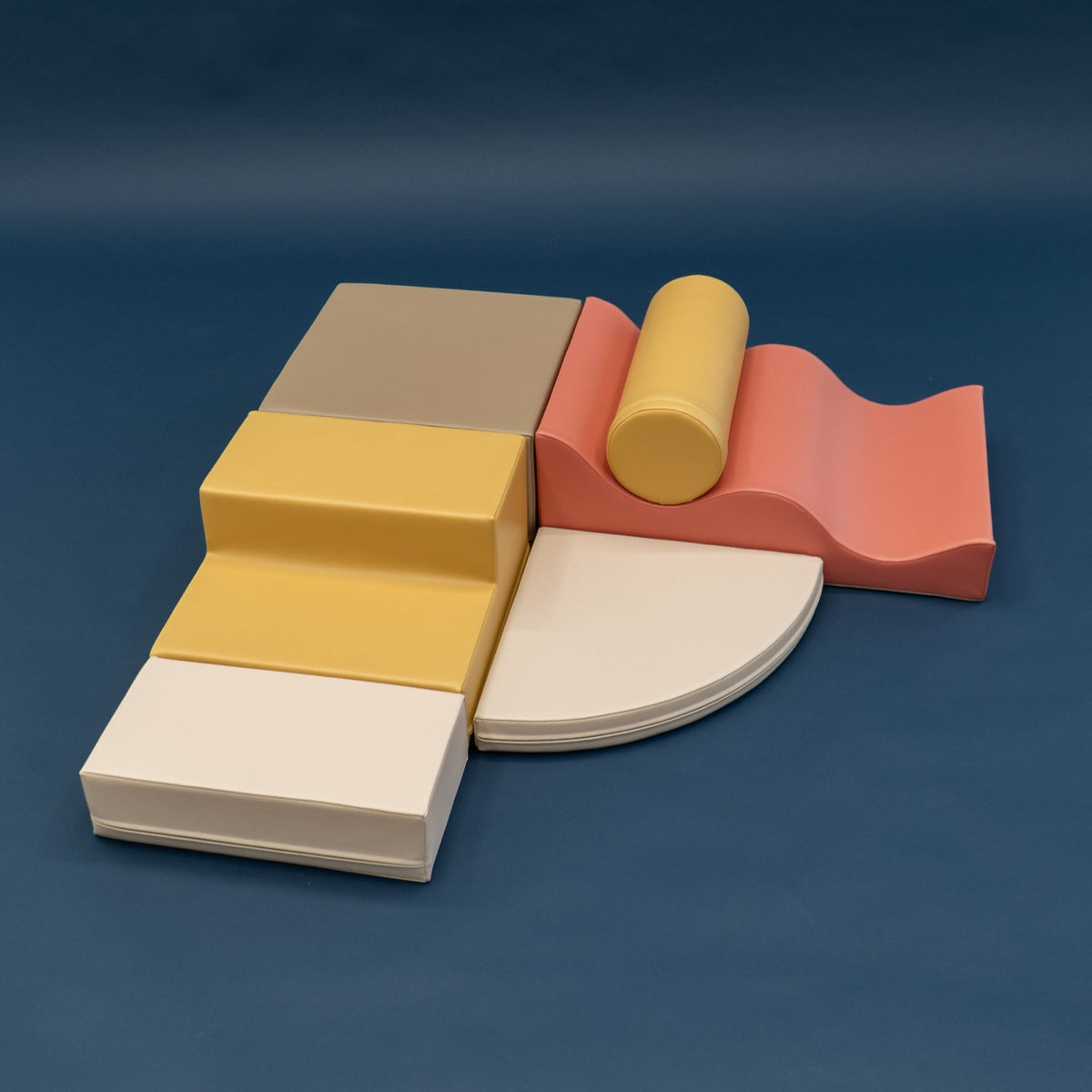 2. Pastel pink and yellow foam blocks arranged on a dark background