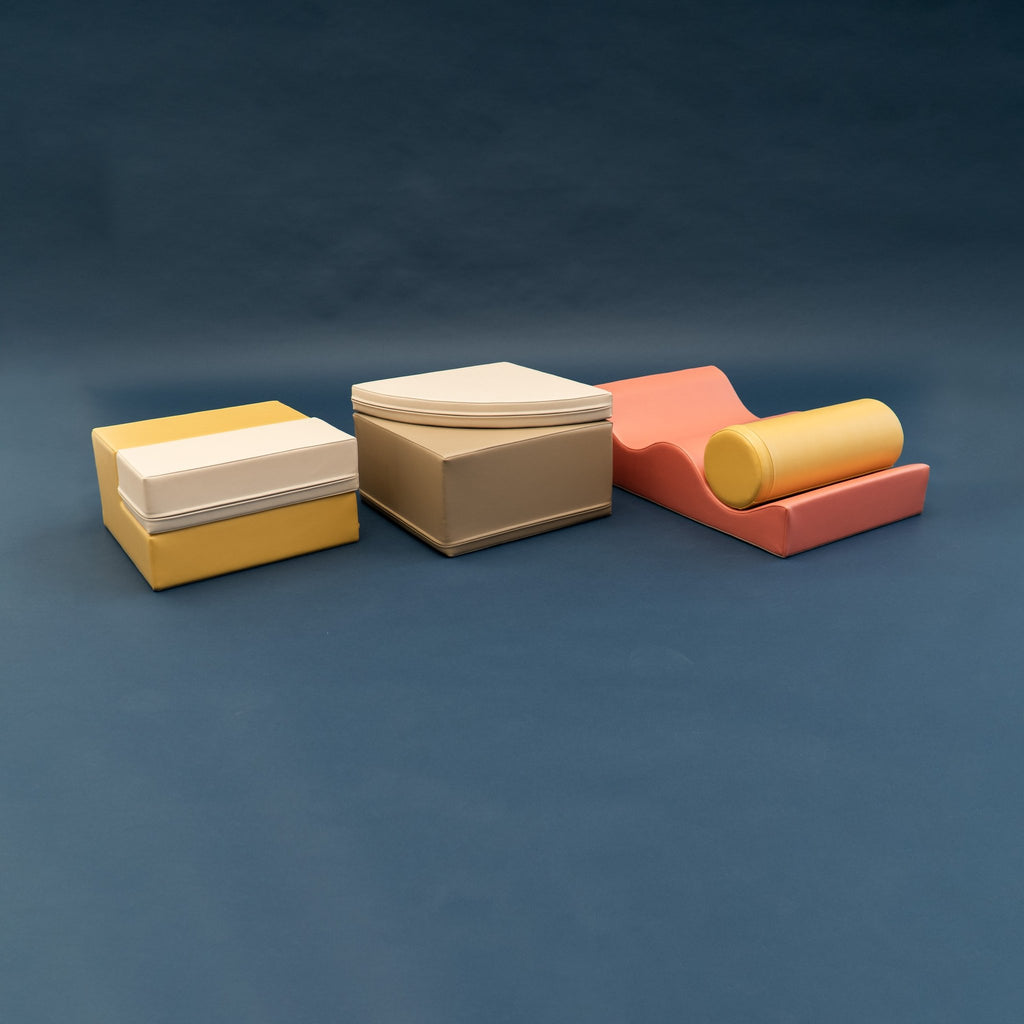 2. Side view of pastel pink and yellow foam blocks on a dark background
