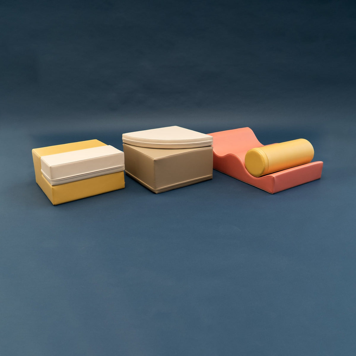 2. Side view of pastel pink and yellow foam blocks on a dark background