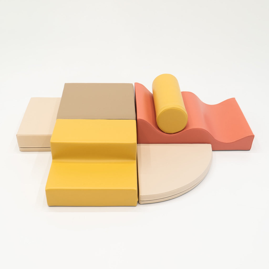 2. Pastel pink and yellow foam blocks arranged on a white background