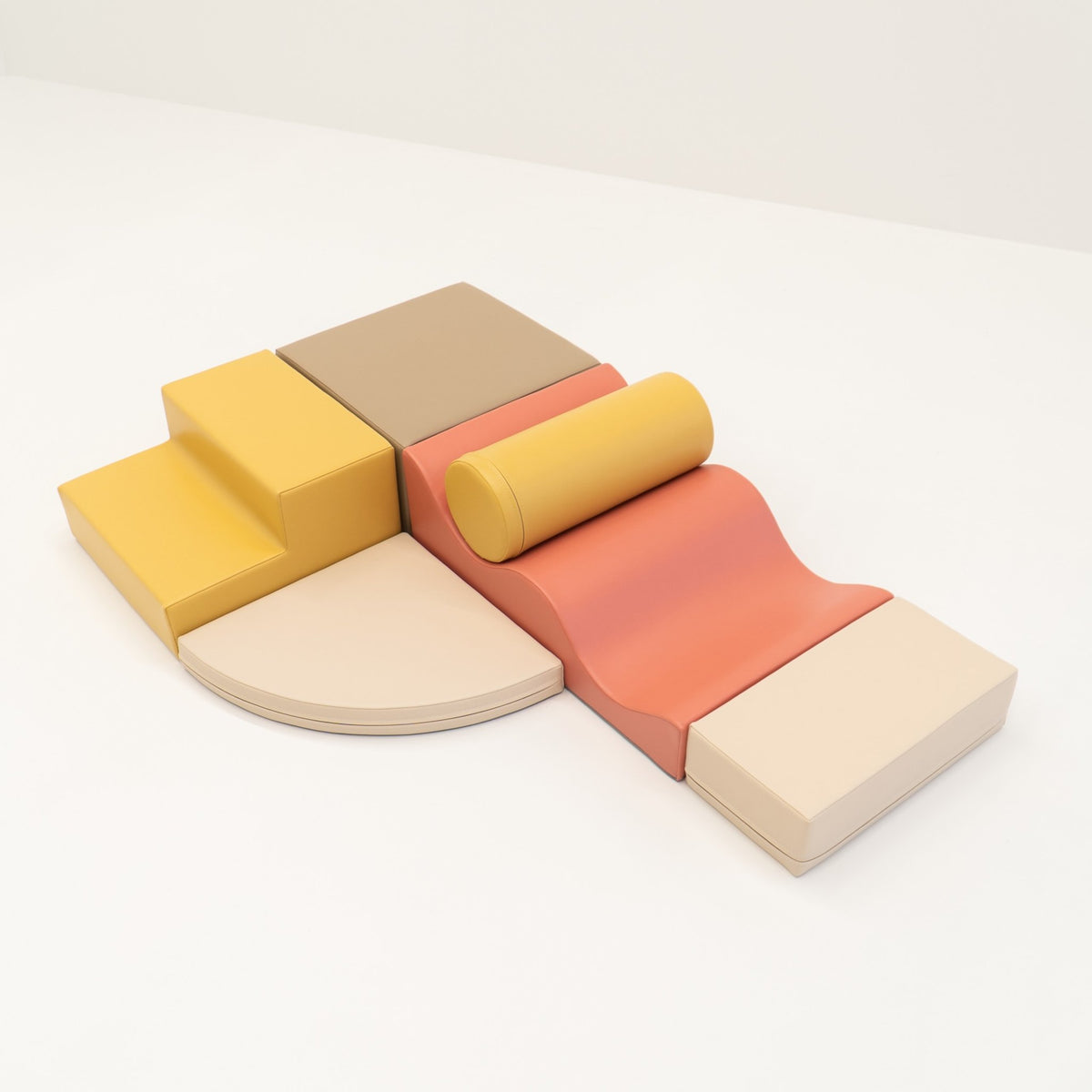 2. Pastel pink and yellow foam blocks arranged on a white background
