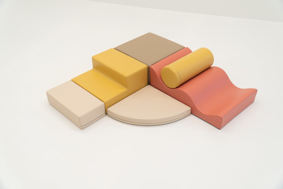 2. Pastel pink and yellow foam blocks arranged on a white background