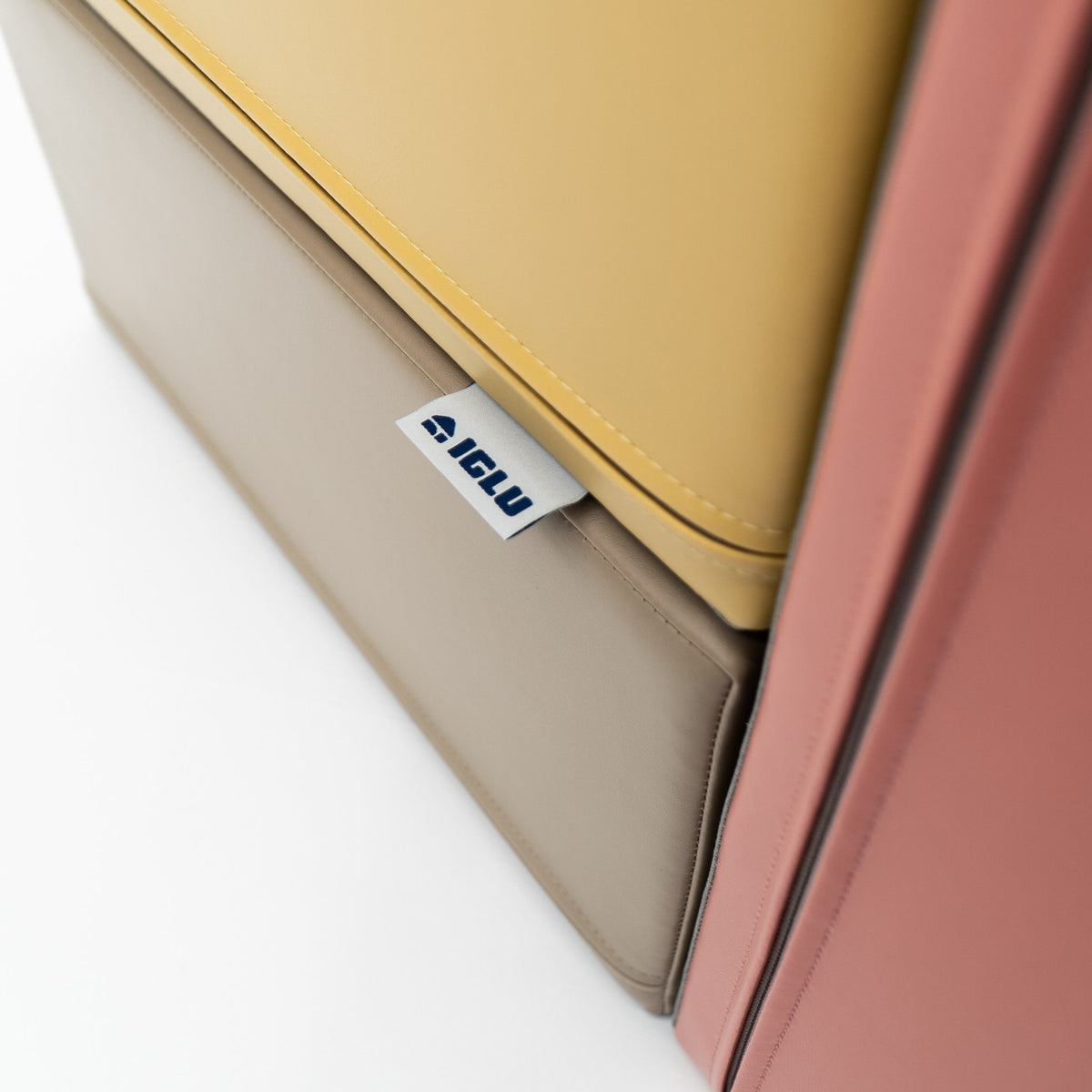 3. Close-up of IGLU logo tag on pastel pink and yellow foam block
