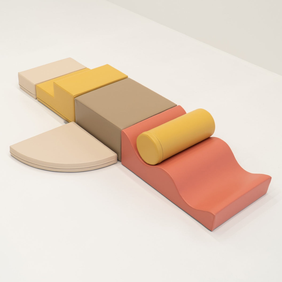 2. Pastel pink and yellow foam blocks arranged on a white background