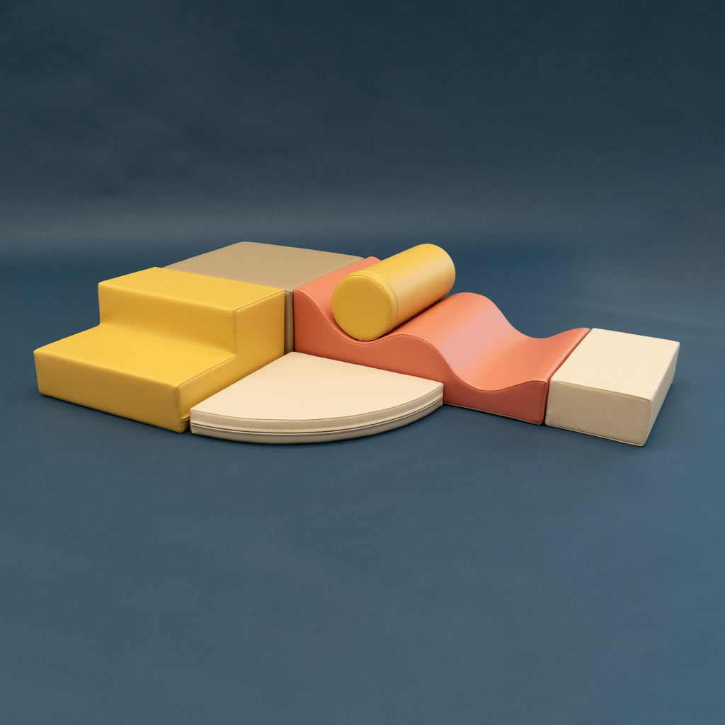 2. Pastel pink and yellow foam block set on a dark background