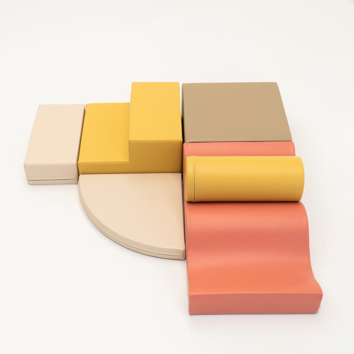 2. Pastel pink and yellow foam blocks arranged on a white background