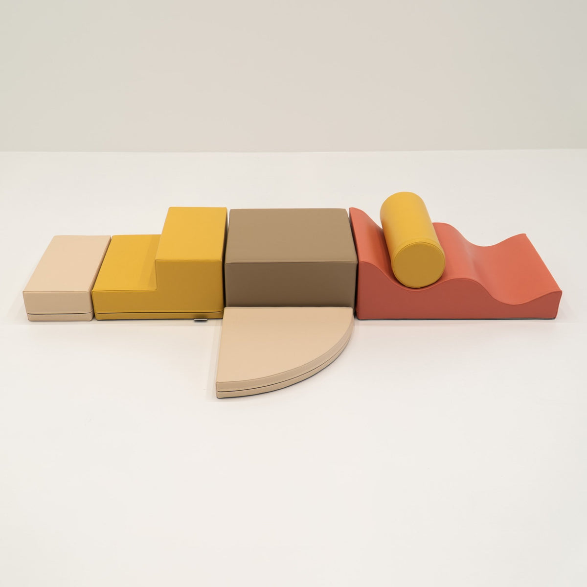 2. Pastel pink and yellow foam blocks arranged on a white background