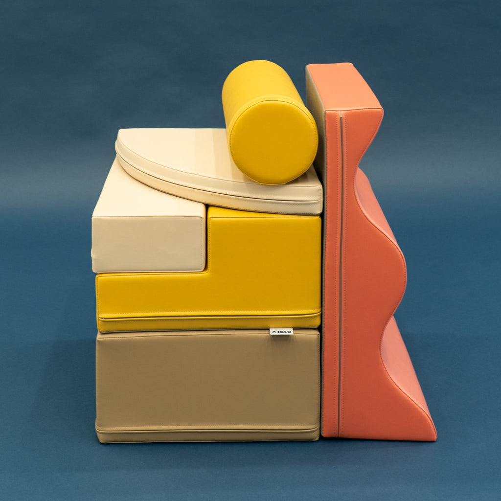 2. Stacked pastel pink and yellow foam blocks on a dark background