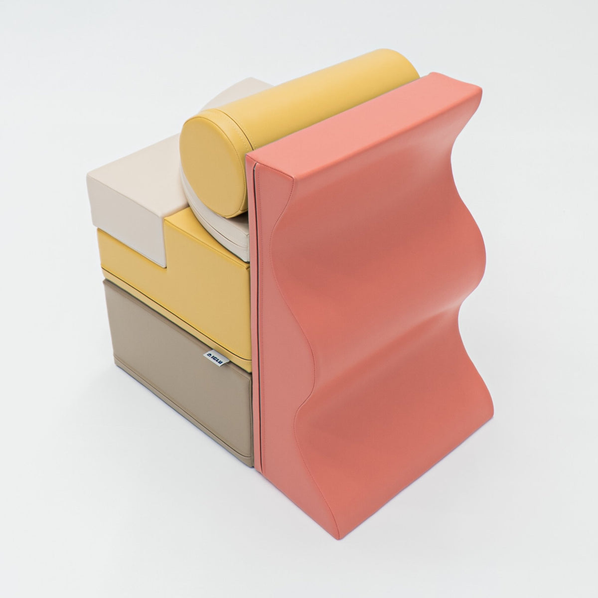 2. Stacked pastel pink and yellow foam blocks on a white background