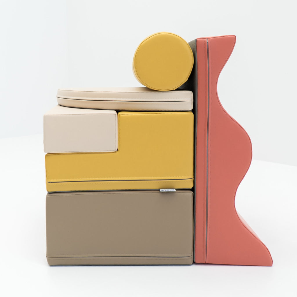 2. Stacked pastel pink and yellow foam blocks on a white background