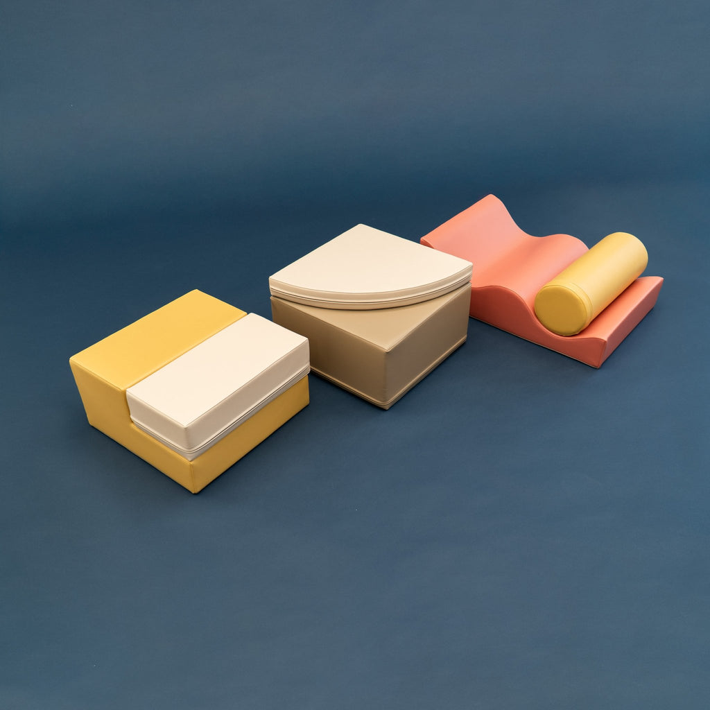 2. Side view of pastel pink and yellow foam blocks on a dark background