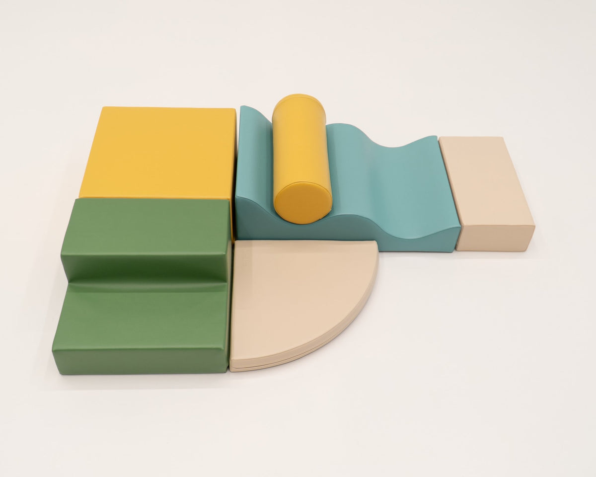 12. IGLU Explorer Set with pastel turquoise, yellow, and green foam blocks arranged in a semi-circle