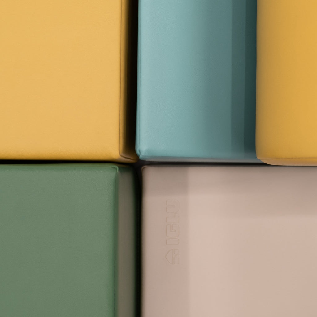 16. Close-up of IGLU Explorer Set showing pastel turquoise, yellow, and green foam blocks with smooth edges