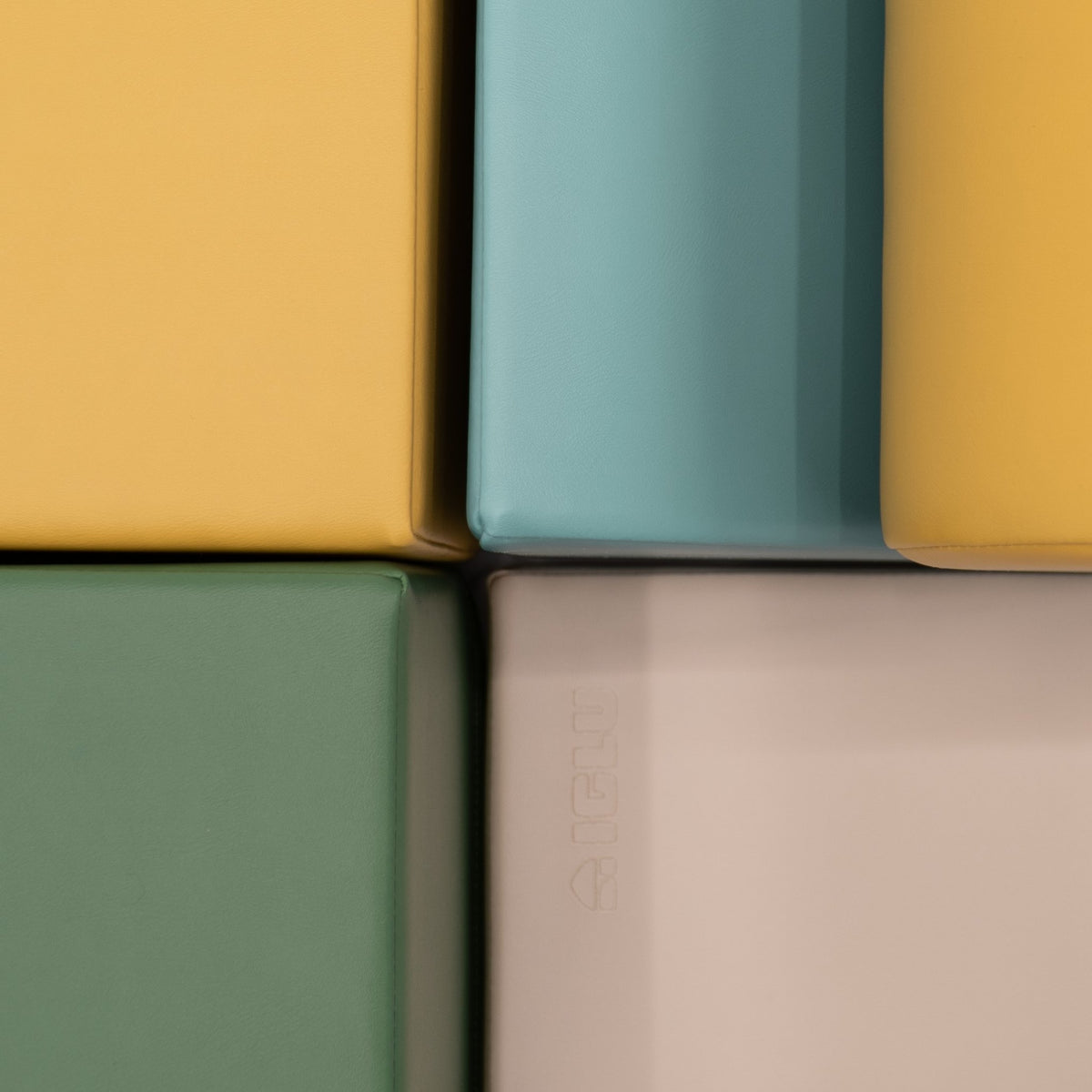 16. Close-up of IGLU Explorer Set showing pastel turquoise, yellow, and green foam blocks with smooth edges