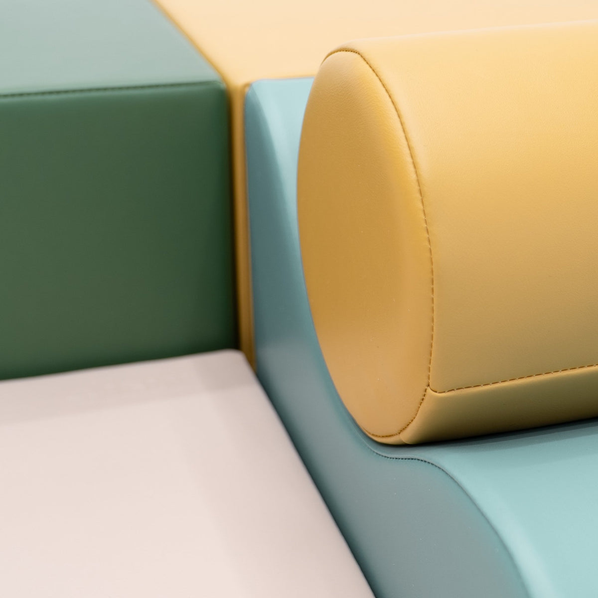 15. Close-up of IGLU Explorer Set showing pastel turquoise, yellow, and green foam blocks with rounded shapes