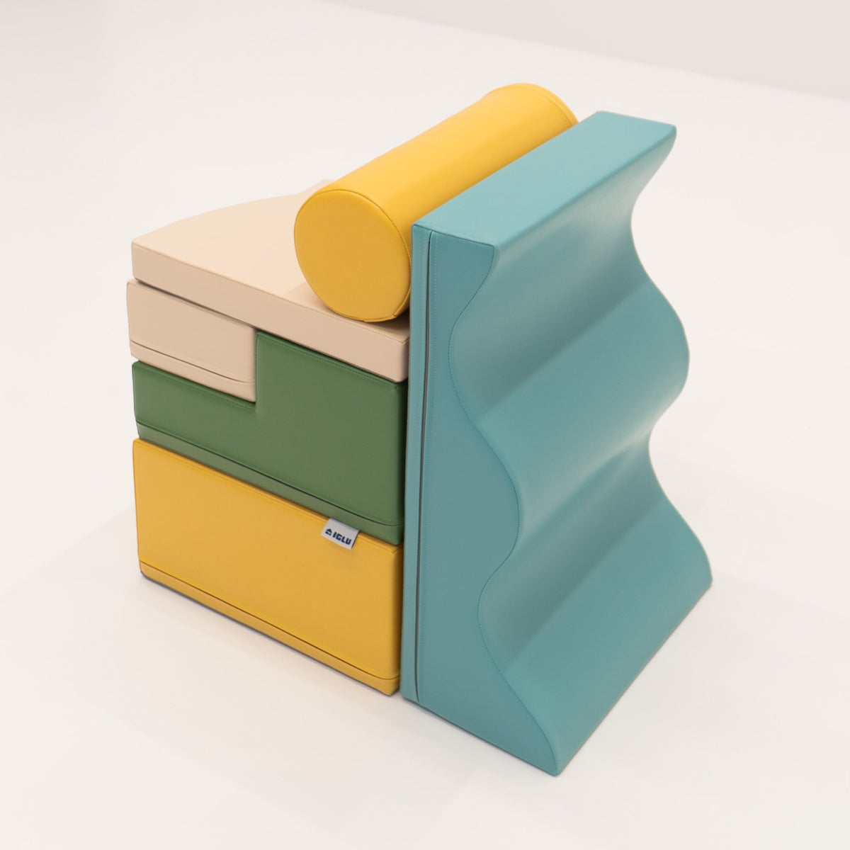 25. Side view of stacked IGLU Explorer Set with pastel turquoise, yellow, and green foam blocks