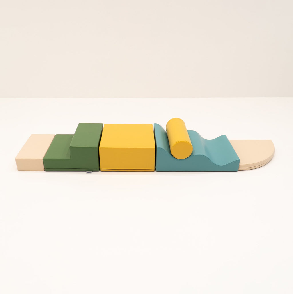 26. Side view of IGLU Explorer Set with pastel turquoise, yellow, and green foam blocks arranged in a line
