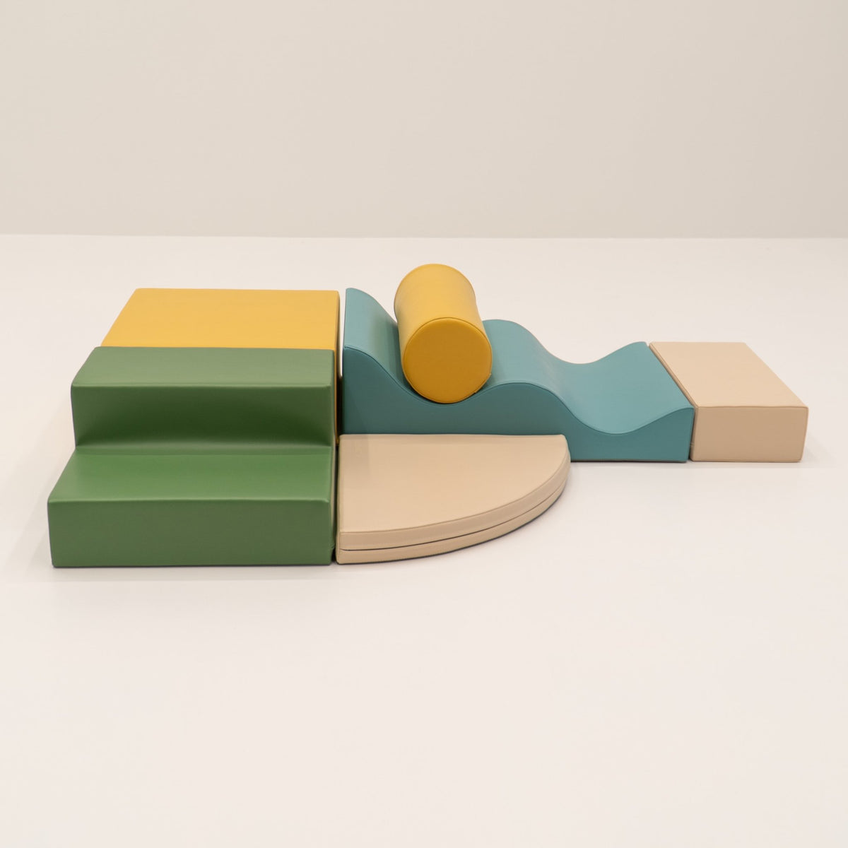 13. IGLU Explorer Set with pastel turquoise, yellow, and green foam blocks arranged in a semi-circle