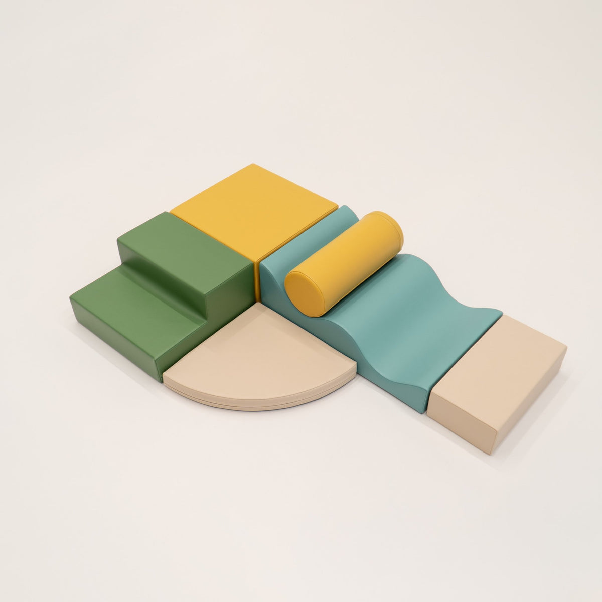 11. IGLU Explorer Set with pastel turquoise, yellow, and green foam blocks arranged in a semi-circle