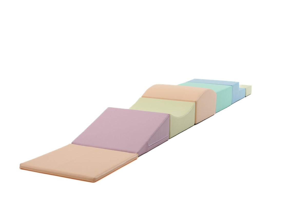 2. Side view of IGLU Little Crawler foam block set in pastel colors on white background