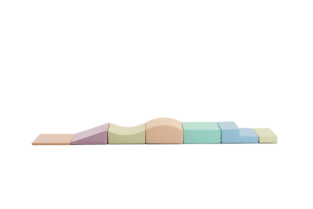 2. IGLU Little Crawler foam block set in pastel colors arranged in a line on white background