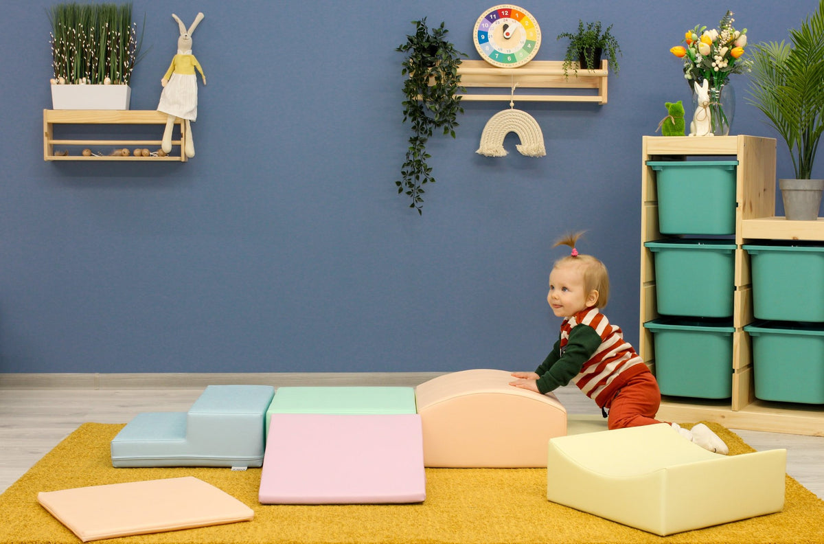 1. Child playing on IGLU Little Crawler pastel foam blocks in a colorful playroom