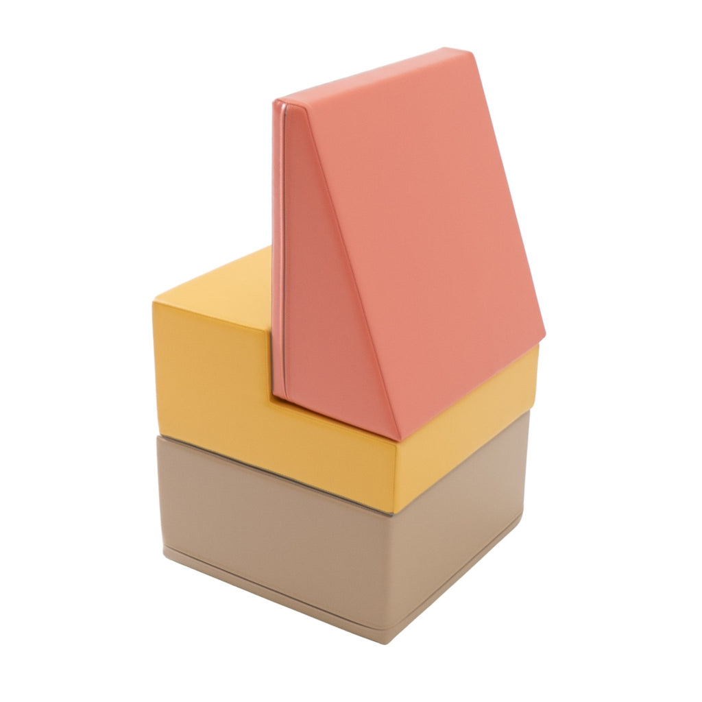 2. IGLU pastel pink, beige, and yellow foam blocks stacked vertically in a studio setting