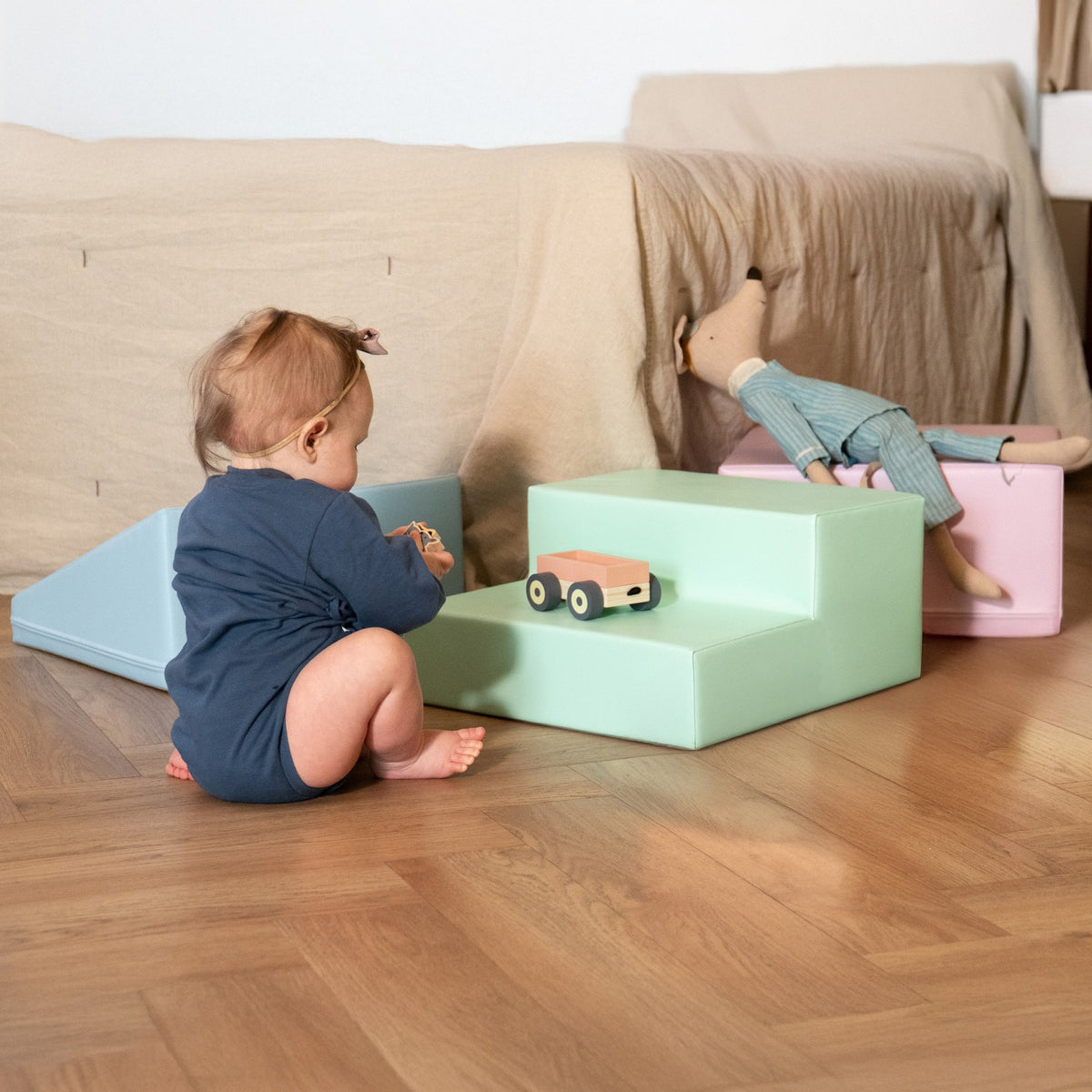 1. Baby playing with IGLU soft pastel foam blocks in a living room setting