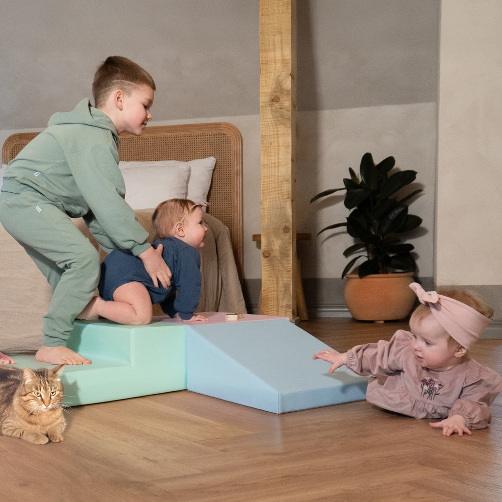 1. Three children playing with IGLU soft pastel foam blocks in a living room